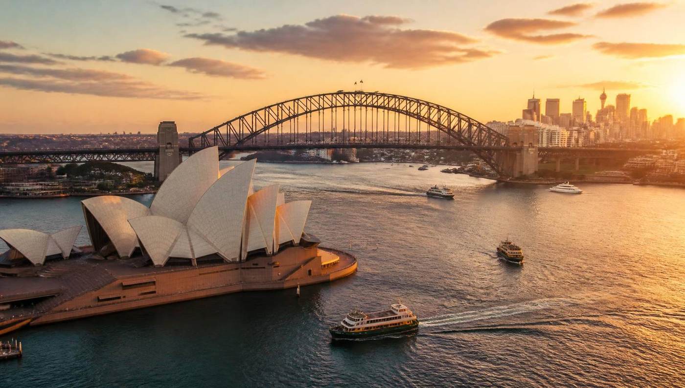 Sydney Harbour at golden hour with the Sydney Opera House, Harbour Bridge and city skyline